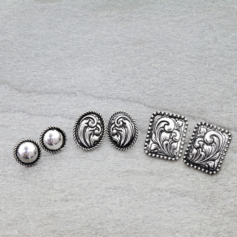 Set of silver earrings on a gray background
