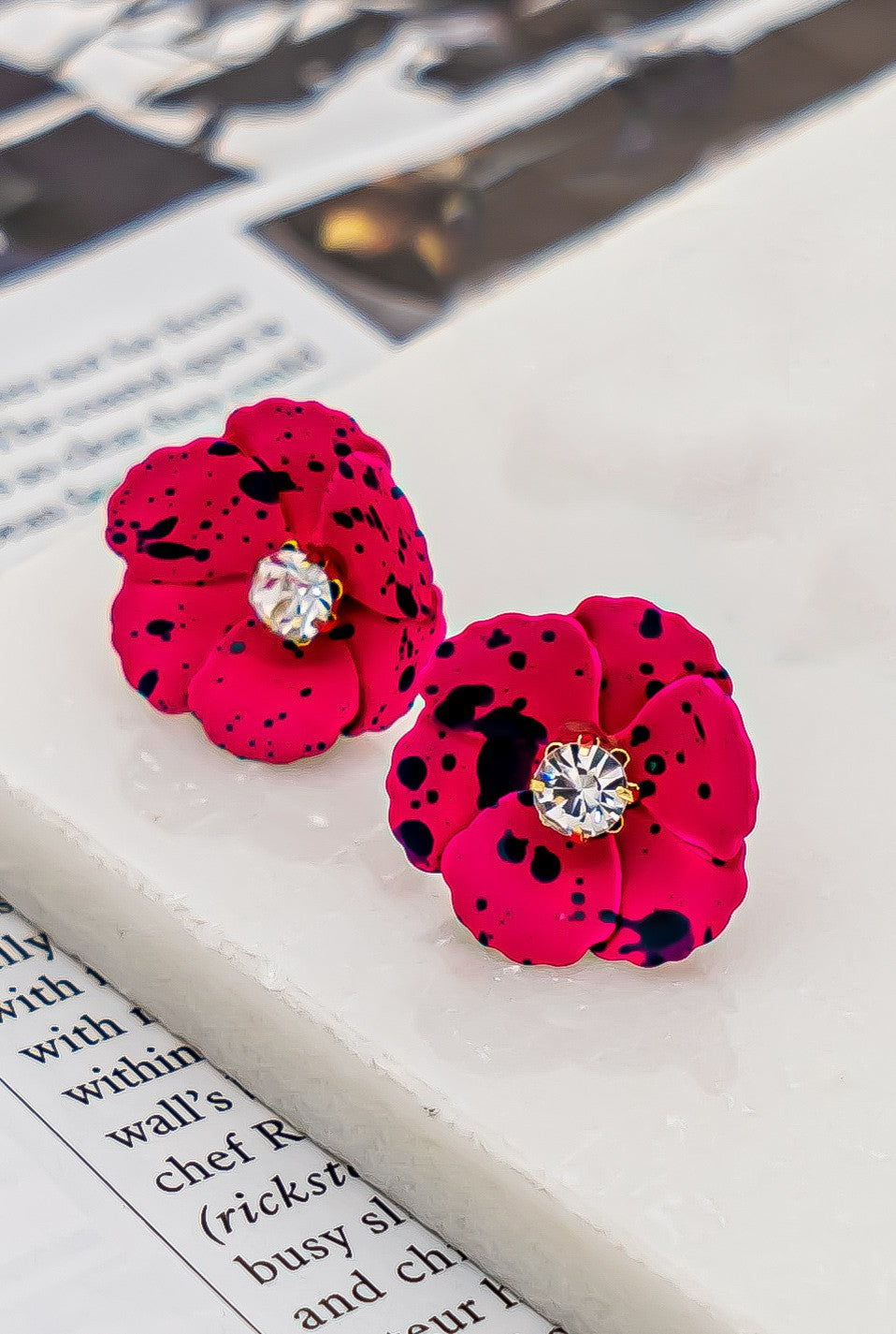 Metal flower earrings with rhinestone center