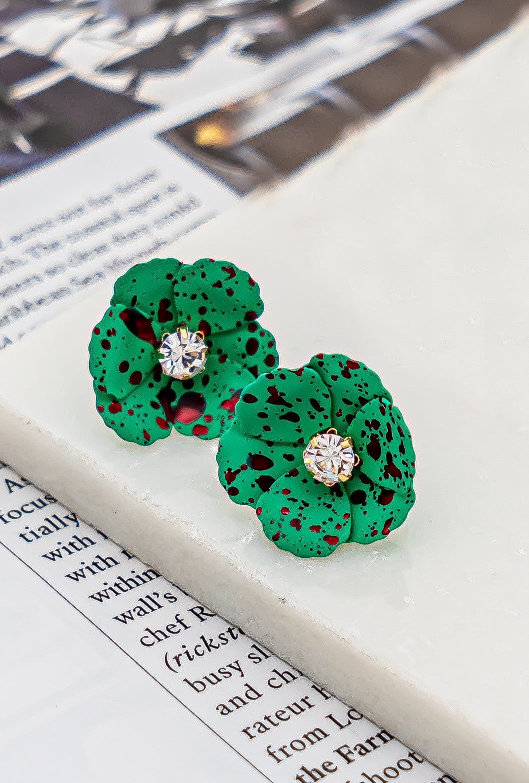 Metal flower earrings with rhinestone center